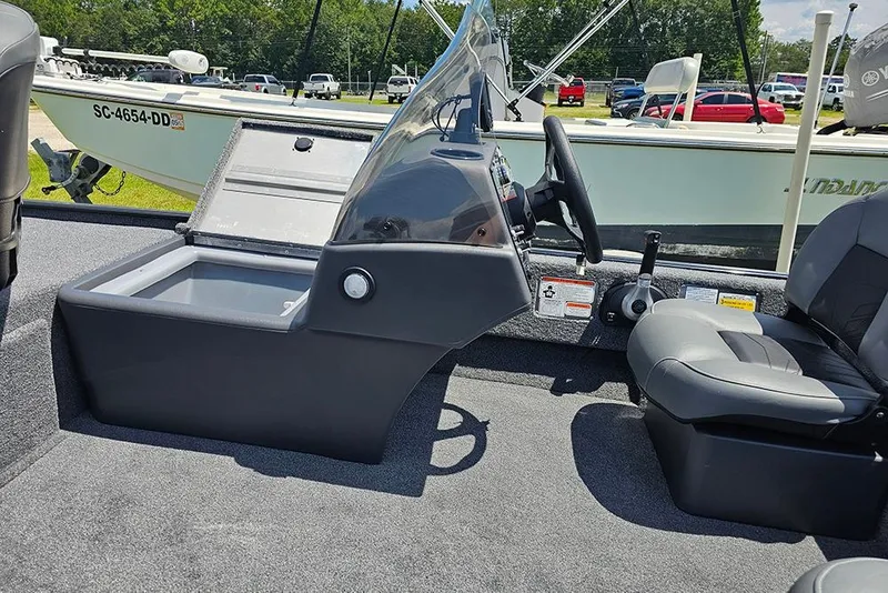 Slide: The Image of 2026 Tracker Bass Tracker Classic XL boat interior with steering console and seating. - 11