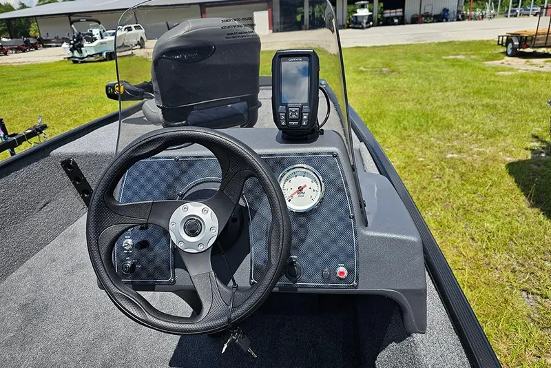 Slide: The Image of 2026 Tracker Bass Tracker Classic XL dashboard with steering wheel and navigation display. - 15