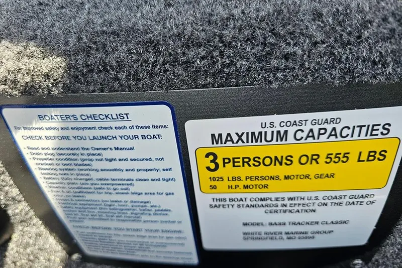 Slide: The Image of 2026 Tracker Bass Tracker Classic XL capacity label and boater's checklist. - 16