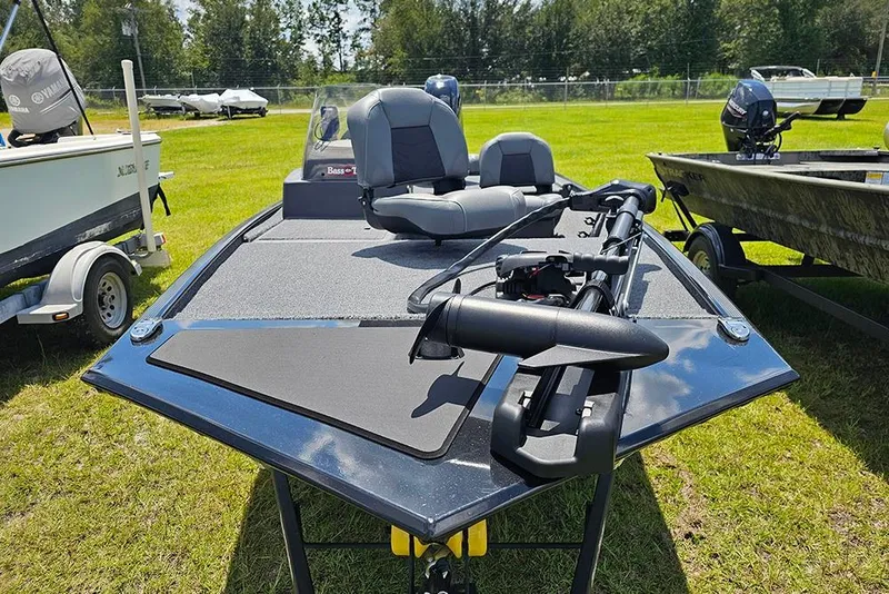 Slide: The Image of 2026 Tracker Bass Tracker Classic XL boat on grassy field, featuring dual seats and trolling motor. - 4