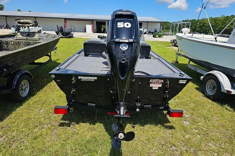Slide: The Image of 2026 Tracker Bass Tracker Classic XL boat with Mercury 50 engine on grass. - 8