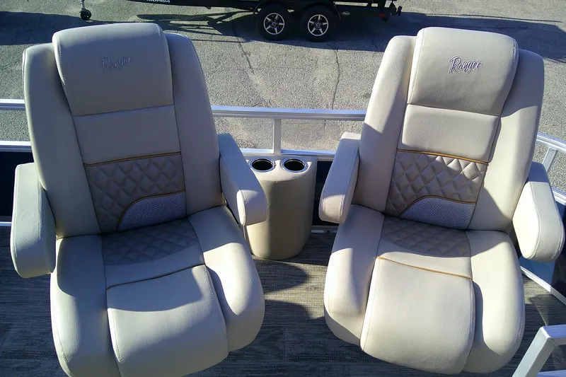 Slide: The Image of 2024 Ranger Reata 220FC boat seats with cup holders, featuring luxurious beige upholstery. - 3