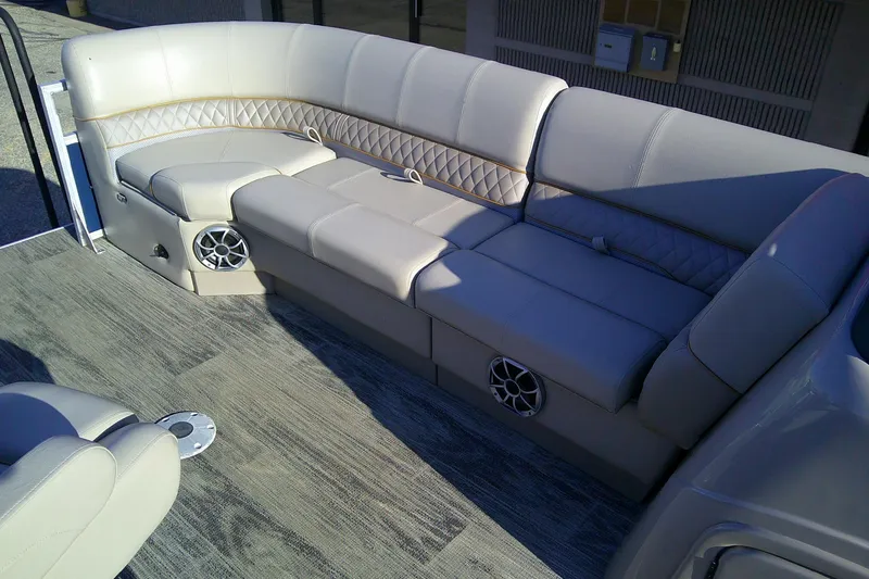 Slide: The Image of 2024 Ranger Reata 220FC boat interior with plush seating and integrated speakers. - 4