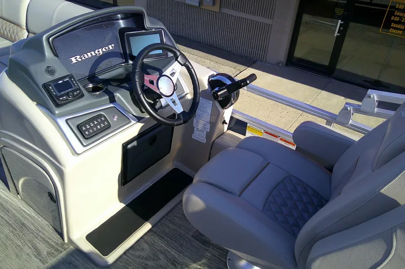 Slide: The Image of 2024 Ranger Reata 220FC boat cockpit with steering wheel and control panel. - 5