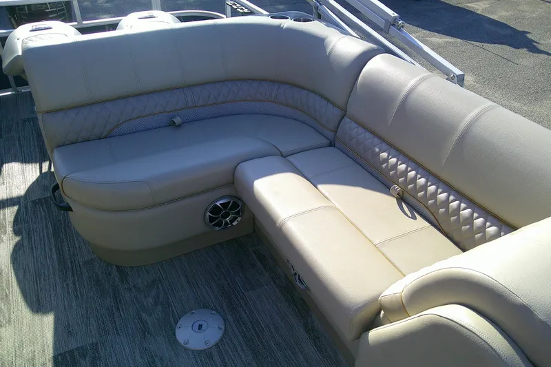 Slide: The Image of 2024 Ranger Reata 220FC boat interior with beige cushioned seating and speaker. - 6