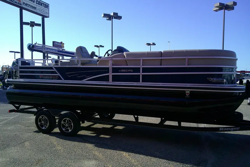 Slide: The Image of 2024 Ranger Reata 220FC pontoon boat on trailer in parking lot. - 82