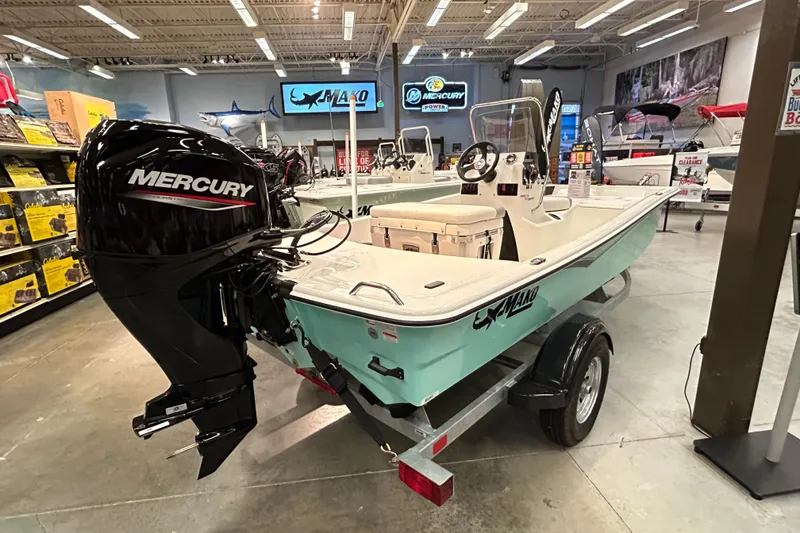 Slide: The Image of 2026 Mako Pro Skiff 15 CC boat with Mercury engine displayed in showroom. - 3