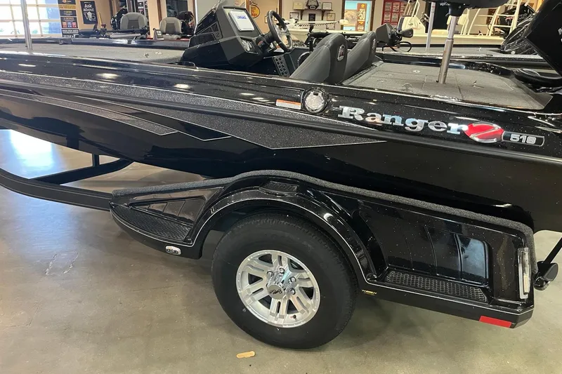 Slide: The Image of 2024 Ranger Z518 Ranger Cup Equipped boat, sleek black design, displayed indoors. - 2