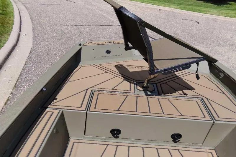 Slide: The Image of 2026 Tracker Grizzly 1650 T Prairie Wings Edition boat with seating on deck. - 2