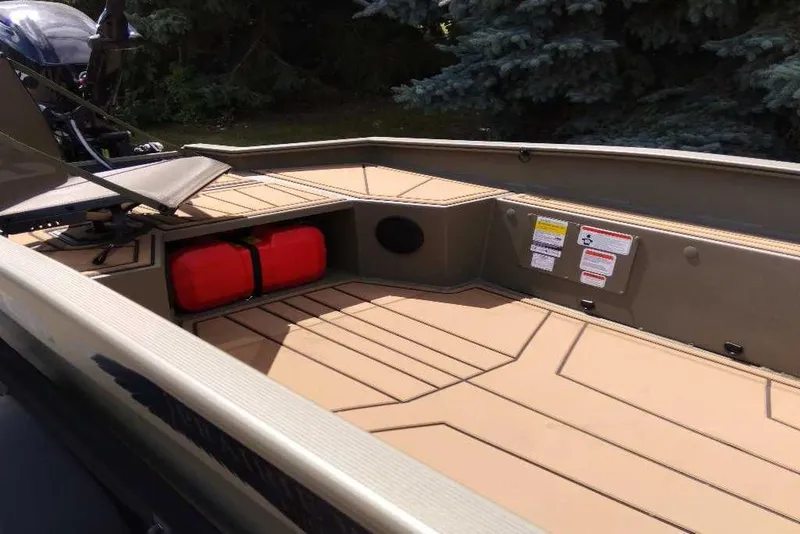 Slide: The Image of 2026 Tracker Grizzly 1650 T Prairie Wings Edition boat interior with storage and seating. - 3
