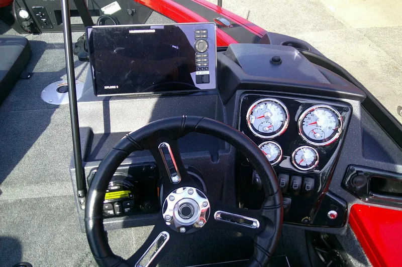 Slide: The Image of 2026 Tracker Targa V-18 Combo dashboard with steering wheel and instrument panel. - 11