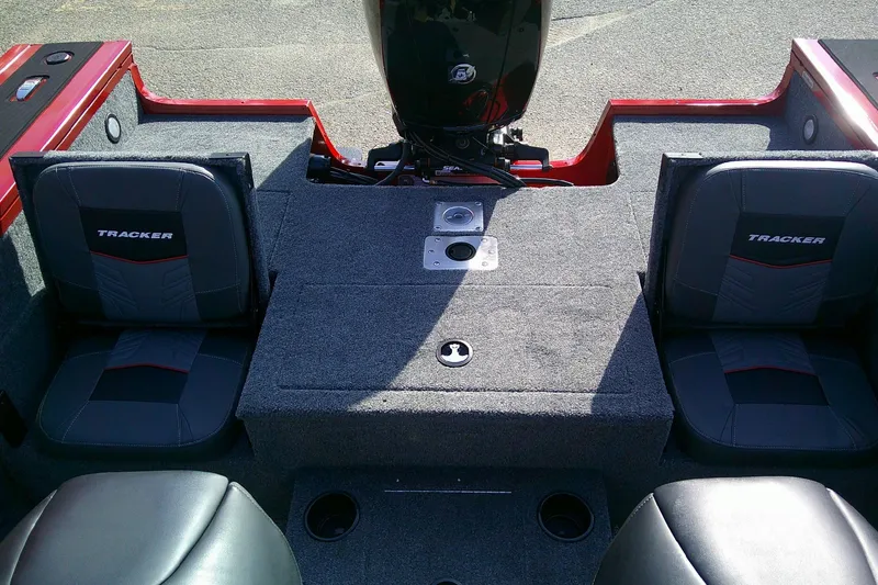 Slide: The Image of 2026 Tracker Targa V-18 Combo boat interior with cushioned seating and motor area. - 12