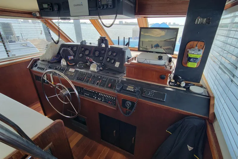 Slide: The Image of Helm of 1985 Chris-Craft 500 Constellation yacht with navigation equipment and steering wheel. - 13