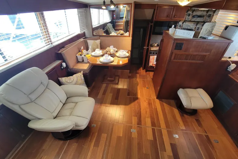 Slide: The Image of Interior of 1985 Chris-Craft 500 Constellation yacht with elegant wood flooring and cozy seating. - 17
