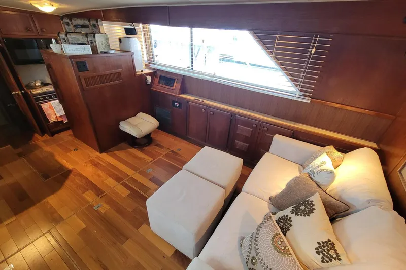 Slide: The Image of Luxurious 1985 Chris-Craft 500 Constellation yacht interior with elegant wood paneling and cozy seating. - 18