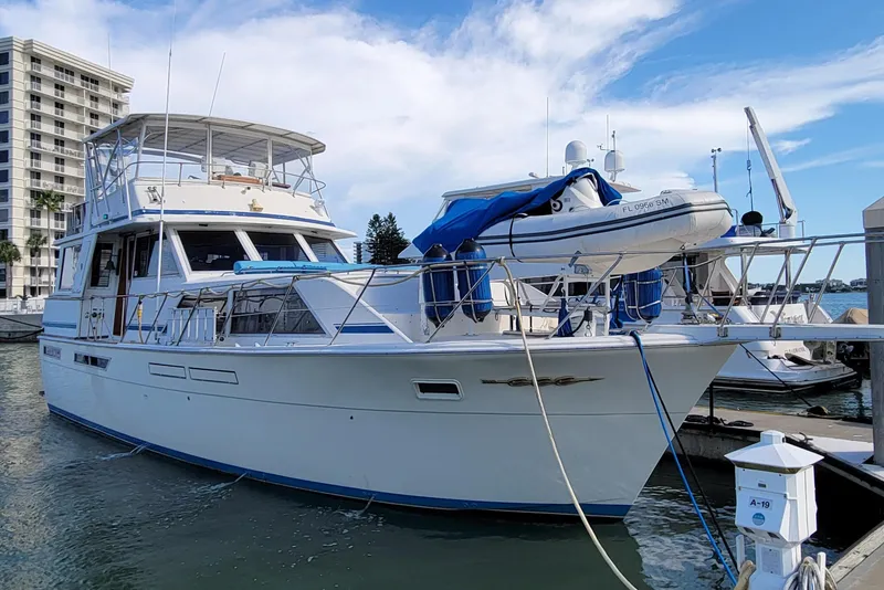 Slide: The Image of 1985 Chris-Craft 500 Constellation yacht docked at marina, clear sky background. - 2