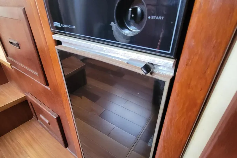 Slide: The Image of 1985 Chris-Craft 500 Constellation interior with wooden cabinetry and built-in appliance. - 22