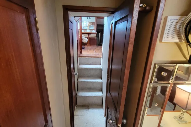 Slide: The Image of Interior view of 1985 Chris-Craft 500 Constellation yacht, featuring wooden doors and carpeted stairs. - 25