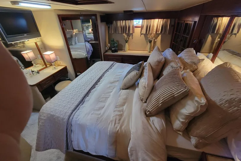 Slide: The Image of Luxurious bedroom interior of 1985 Chris-Craft 500 Constellation yacht with elegant bedding and decor. - 26