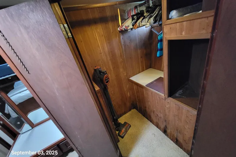 Slide: The Image of 1985 Chris-Craft 500 Constellation interior closet with wooden paneling and storage shelves. - 28