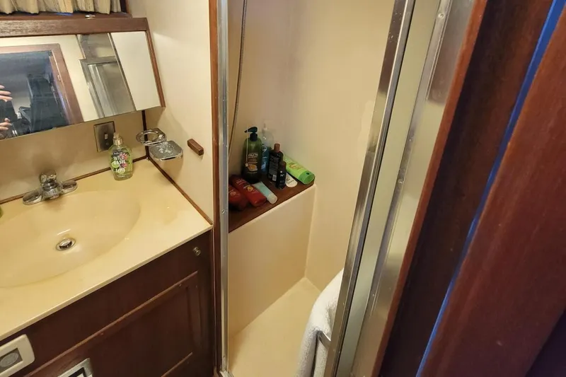 Slide: The Image of 1985 Chris-Craft 500 Constellation bathroom with sink, mirror, and shower area. - 31
