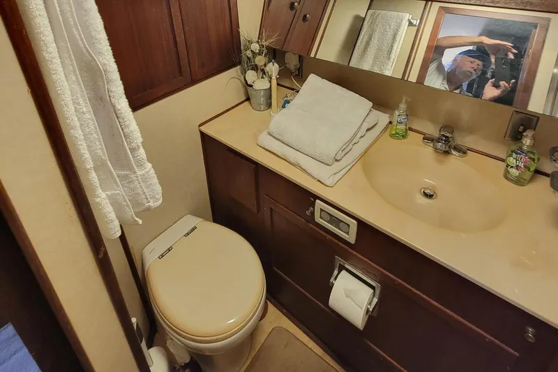 Slide: The Image of 1985 Chris-Craft 500 Constellation bathroom with sink, toilet, and mirror. - 32