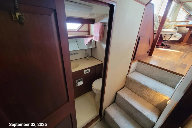 Slide: The Image of 1985 Chris-Craft 500 Constellation yacht interior with bathroom and stairs, dated September 3, 2025. - 33