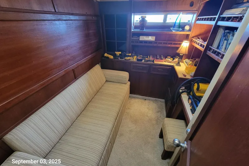 Slide: The Image of Cozy interior of 1985 Chris-Craft 500 Constellation yacht with sofa and wooden shelves. - 34
