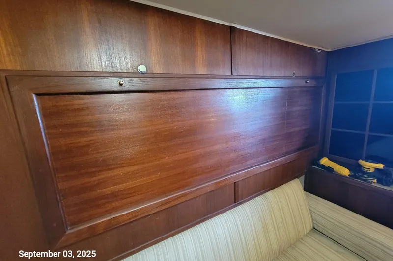Slide: The Image of Interior of 1985 Chris-Craft 500 Constellation yacht with wooden paneling and beige seating. - 35
