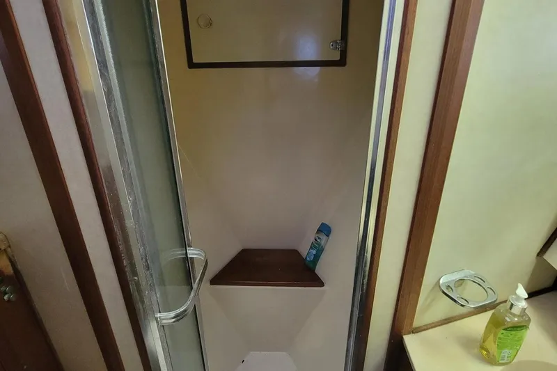 Slide: The Image of Shower area inside 1985 Chris-Craft 500 Constellation yacht with wooden accents. - 42