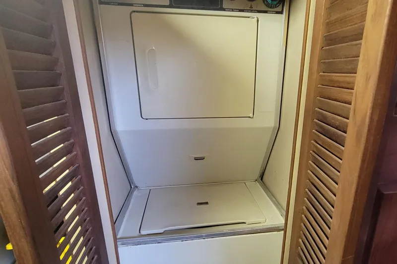 Slide: The Image of Laundry area inside 1985 Chris-Craft 500 Constellation yacht with wooden louvered doors. - 43