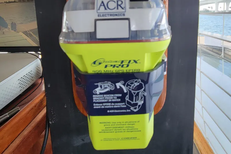 Slide: The Image of ACR Electronics beacon on 1985 Chris-Craft 500 Constellation yacht, docked by water. - 45