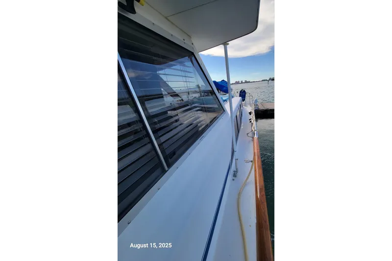 Slide: The Image of 1985 Chris-Craft 500 Constellation yacht docked, side view with clear sky and water. - 53
