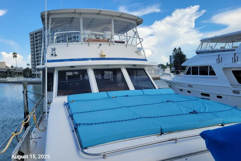 Slide: The Image of 1985 Chris-Craft 500 Constellation yacht docked, blue cushions on deck, clear sky. - 55