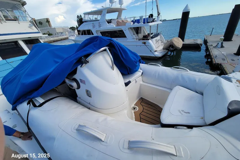 Slide: The Image of 1985 Chris-Craft 500 Constellation yacht docked, with inflatable boat and blue cover, August 15, 2025. - 57