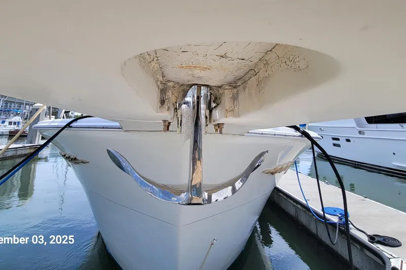 Slide: The Image of 1985 Chris-Craft 500 Constellation yacht docked, showing hull and anchor detail. - 59