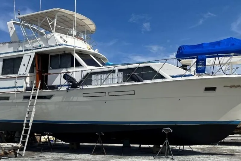 Slide: The Image of 1985 Chris-Craft 500 Constellation yacht on dry dock under clear blue sky. - 62