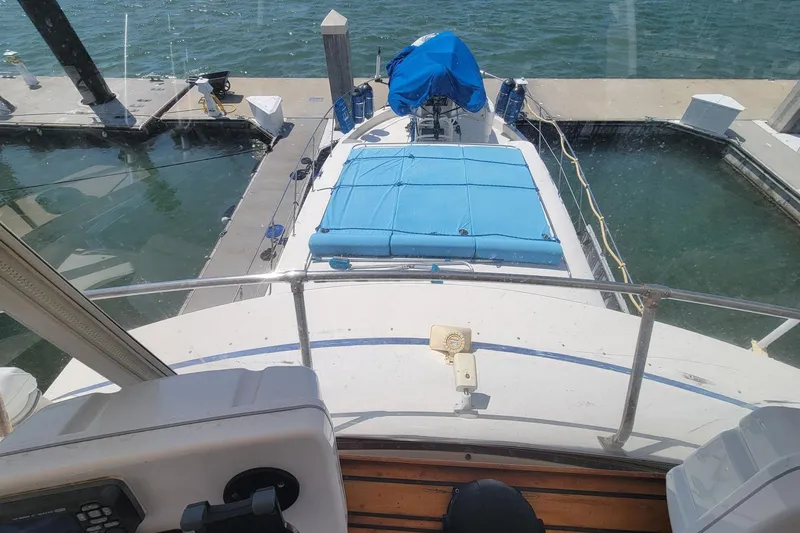Slide: The Image of 1985 Chris-Craft 500 Constellation yacht docked at marina, view from helm. - 7