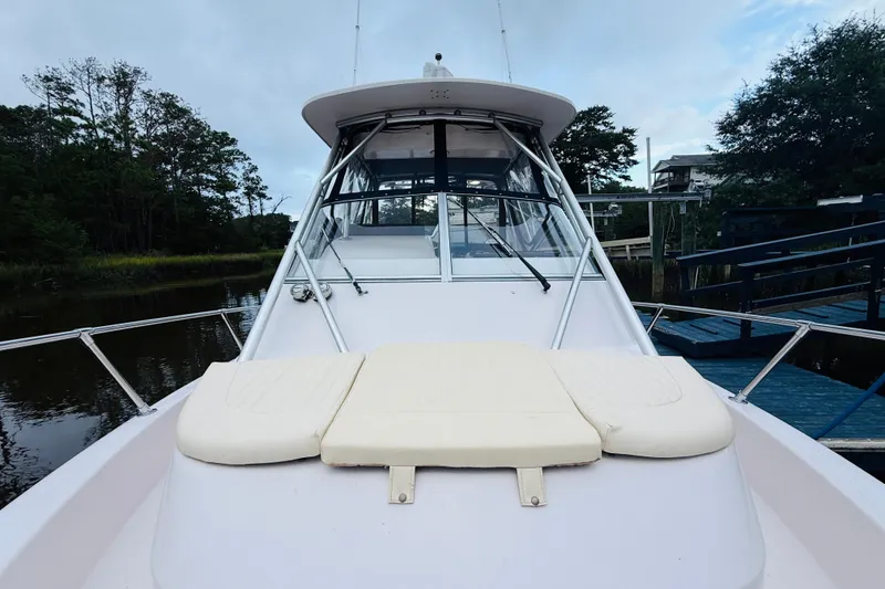 Slide: The Image of 2003 Grady-White Sailfish 282 boat docked, featuring spacious deck and cabin. - 10