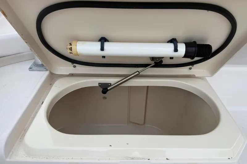 Slide: The Image of Open storage compartment on 2003 Grady-White Sailfish 282 boat, featuring a hydraulic lift. - 14