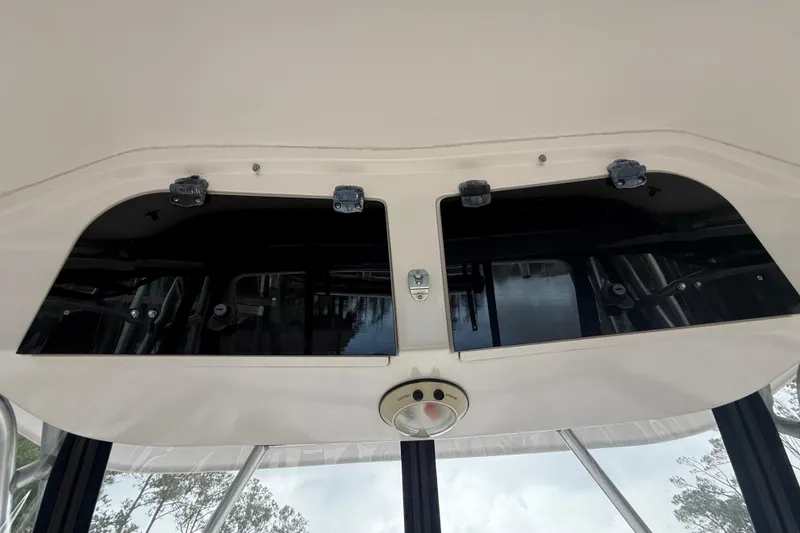 Slide: The Image of 2003 Grady-White Sailfish 282 boat interior storage compartment with black doors and latch. - 17