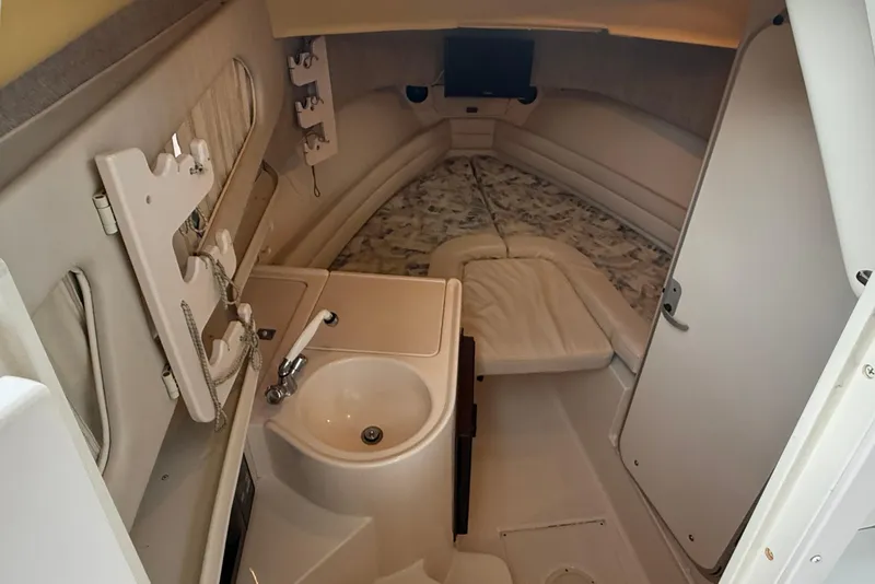 Slide: The Image of 2003 Grady-White Sailfish 282 cabin interior with sink, bed, and storage. - 20