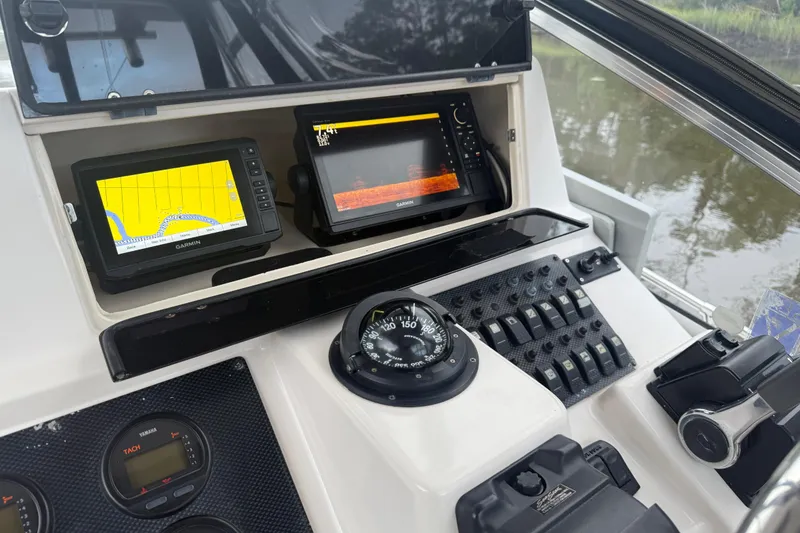 Slide: The Image of 2003 Grady-White Sailfish 282 helm with Garmin navigation and control panel. - 21