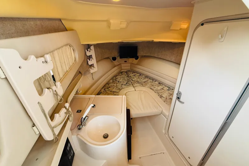 Slide: The Image of 2003 Grady-White Sailfish 282 cabin interior with sink, bed, and storage. - 25