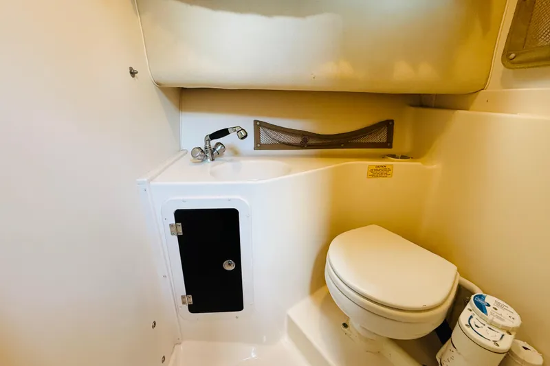 Slide: The Image of 2003 Grady-White Sailfish 282 boat bathroom with sink and toilet. - 29