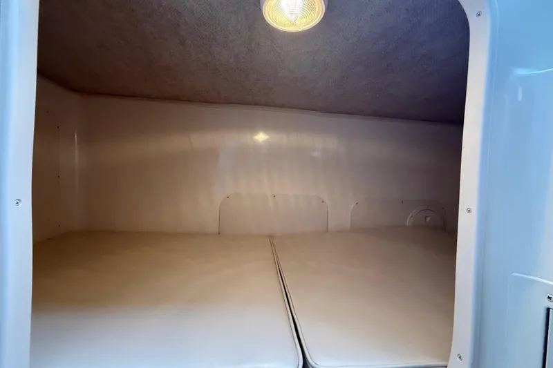 Slide: The Image of 2003 Grady-White Sailfish 282 cabin interior with cushioned sleeping area and overhead light. - 31