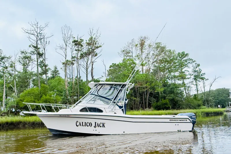 Slide: The Image of 2003 Grady-White Sailfish 282 boat named "Calico Jack" on a serene waterway. - 4