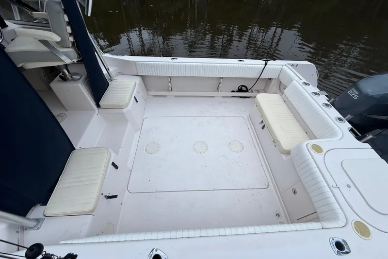 Slide: The Image of 2003 Grady-White Sailfish 282 boat deck with cushioned seating and storage compartments. - 8