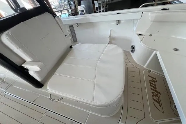 Slide: The Image of 2025 Parker 2600 Center Console boat interior with white seating and branded flooring. - 10