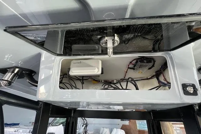 Slide: The Image of 2025 Parker 2600 Center Console electronics compartment with wiring and Garmin device. - 15